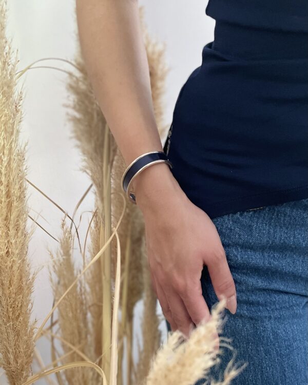 Bracelet bleu Atelier Gahia au poignet, paille marquetée sur base argentée
